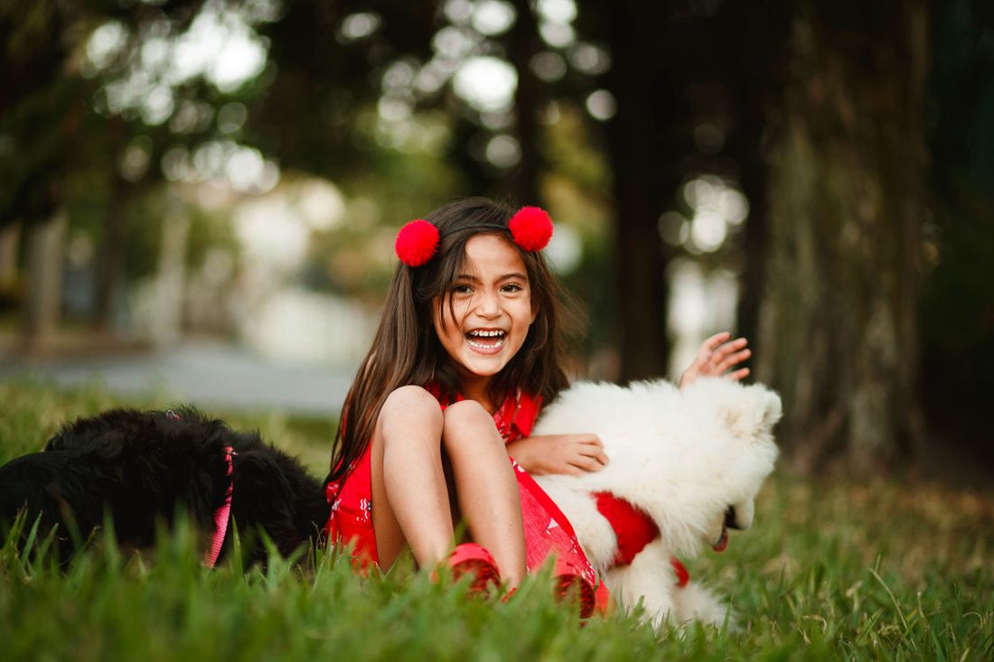 Young child playing with a dog outdoors